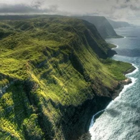 The majestic aerial view of West Maui mountains and sea cliffs during circle island tour in Maui.