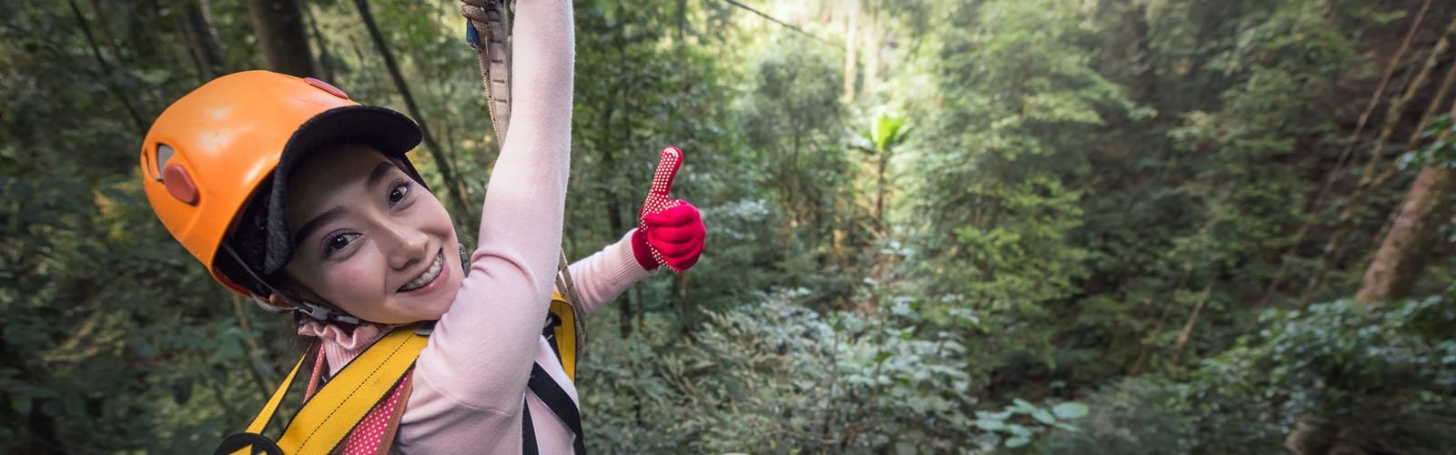 Woman giving thumbs up while on Maui Zipline